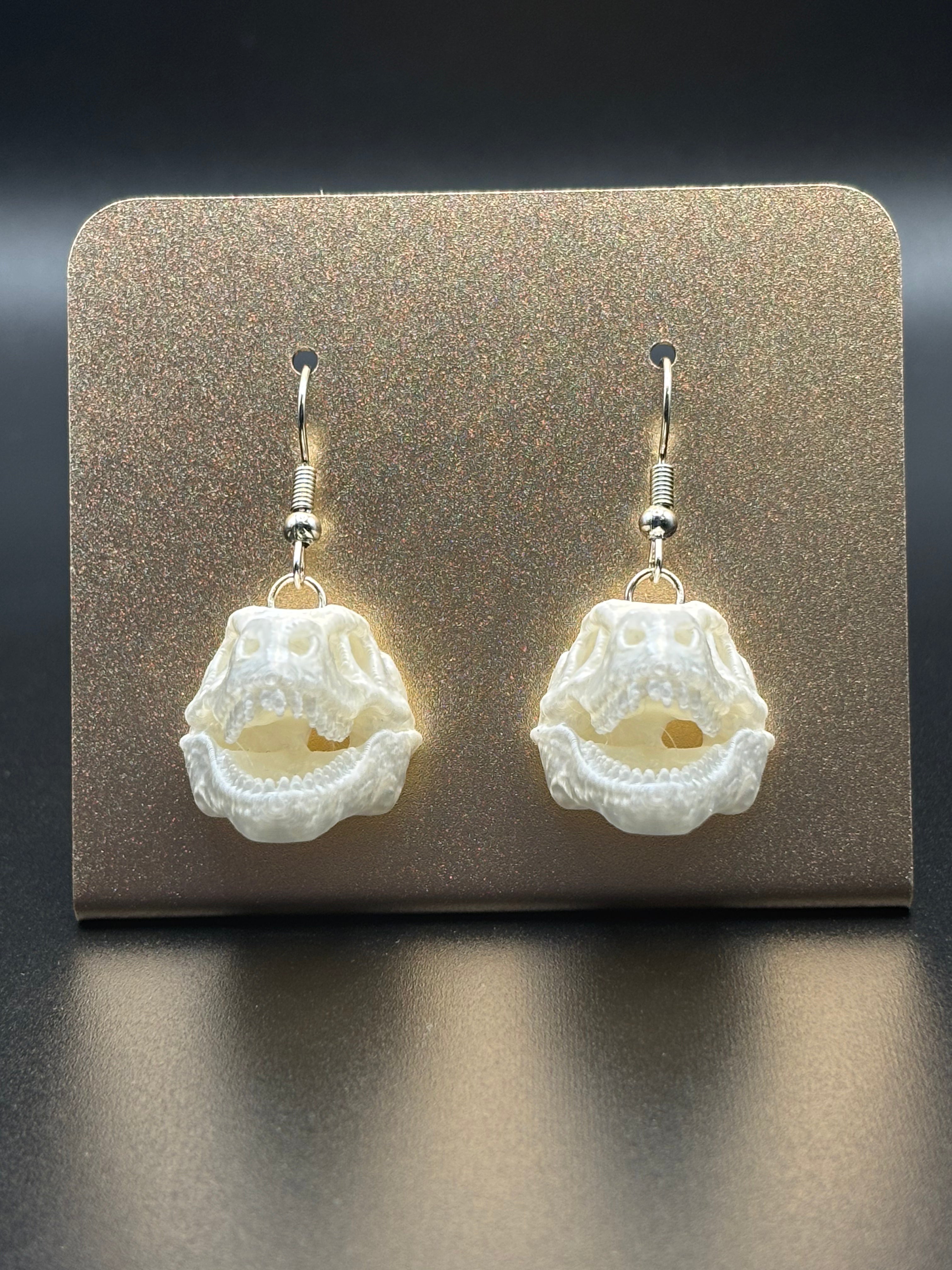 T Rex skull earrings